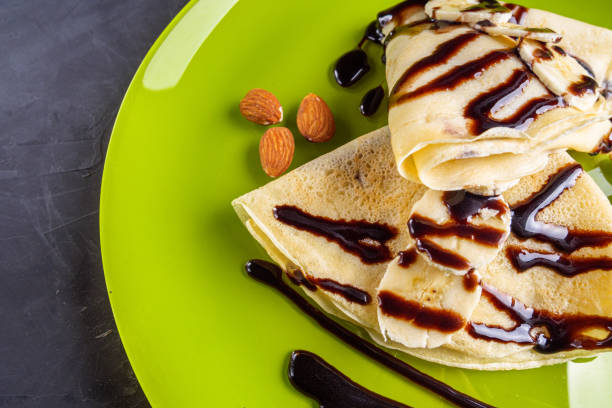 istock crepes with banana and chocolate spread on a green plate 1211229581