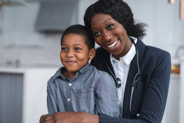 istock A beautiful female nurse hugs a child affectionately 1211231365