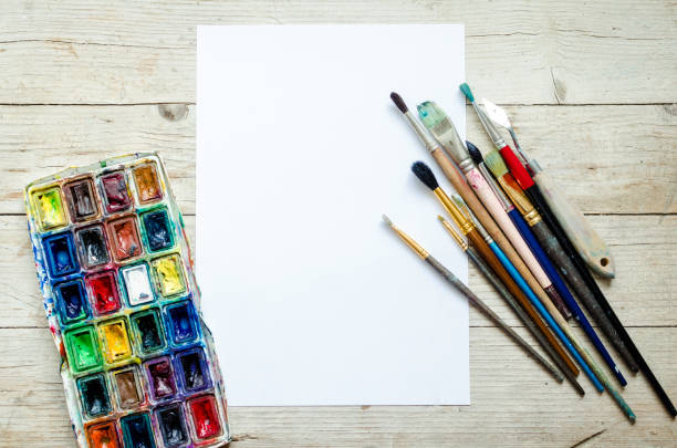 istock Artist paint brushes on the wooden background 1211232697