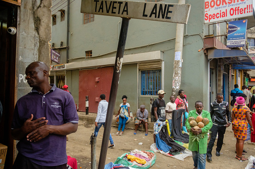 Nairobi, Kenya - August 25, 2018: Locals socialize, shop and sell goods along downtown Nairobi’s busy Accra Road.