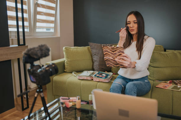 istock Beauty blogger is recording her new Vlog while doing make up. 1211237010