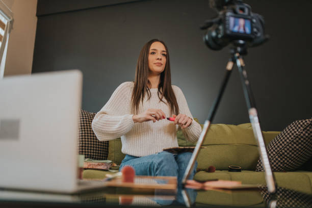 istock Beauty blogger is recording her new Vlog while doing make up. 1211237046
