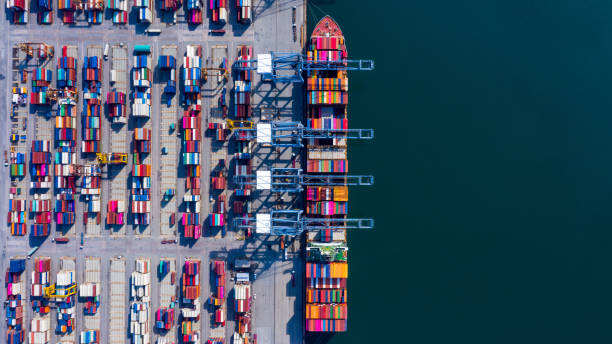 istock Aerial view container cargo ship freight shipping unloading at original destination port with quay crane, Business commercial global oversea logistic import export container box by container vessel . 1211239983