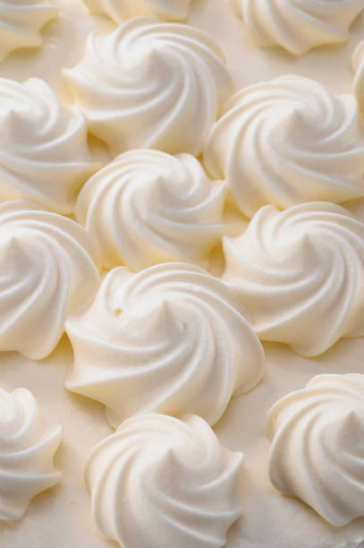 istock cream curls decoration on cake surface close-up 1211243450