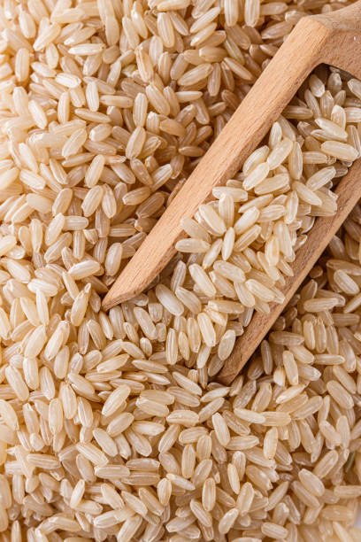 istock raw brown rice on white acrylic background 1211243556
