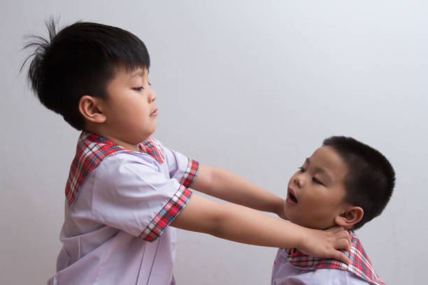 Student fighting over toys. Big students are bullying smaller friends.