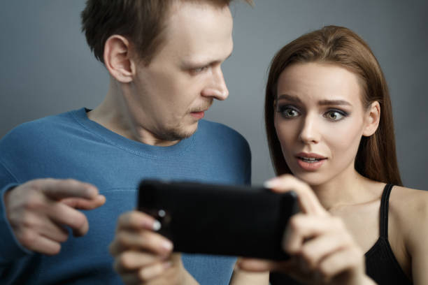 istock Guy with girl is looking at smartphone 1211248282
