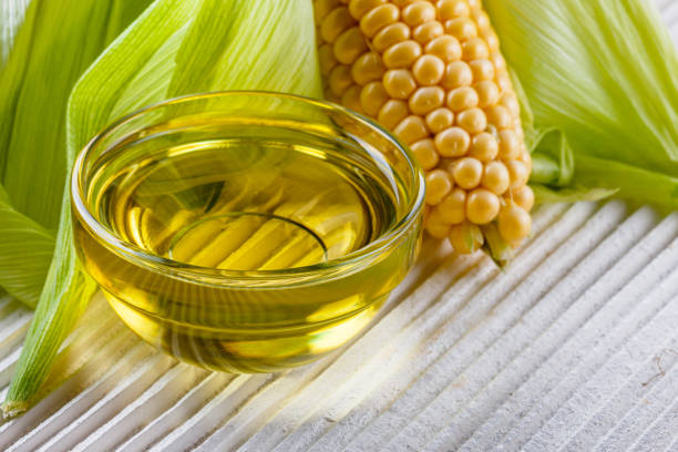 istock corn oil on white wooden rustic background 1211249037