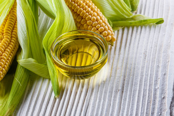 istock corn oil on white wooden rustic background 1211249058