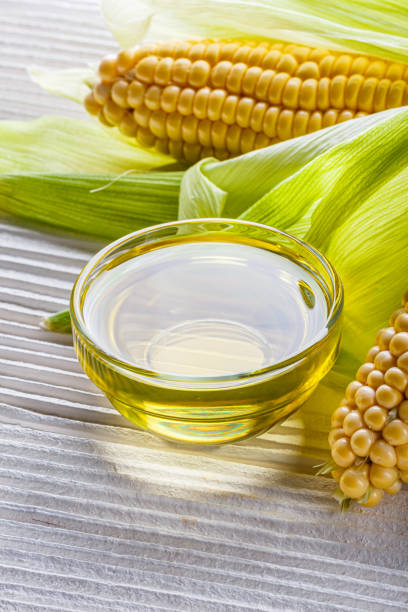 istock corn oil on white wooden rustic background 1211249064