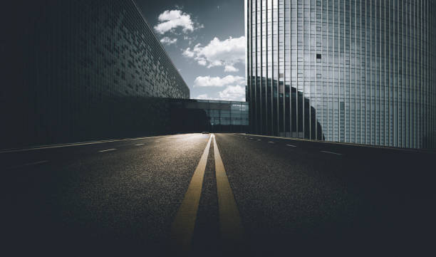 Divided highway passing through city buildings, blue nostalgia high contrast