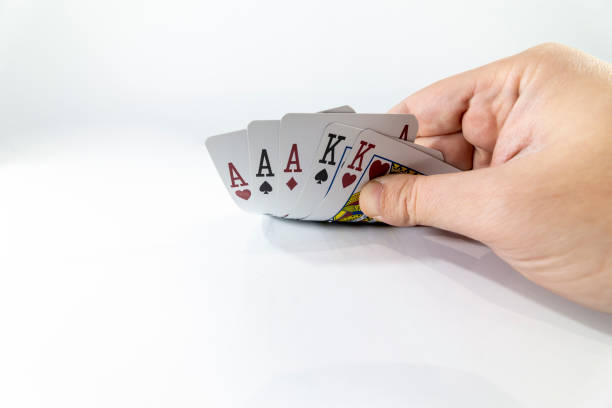 istock Closeup of checking playing cards isolated on white 1211251856