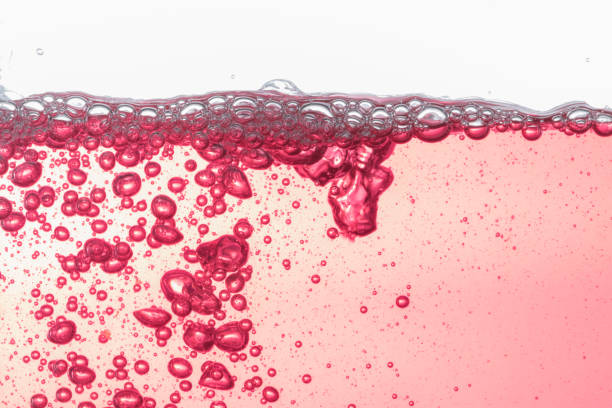 Close up water bubbles underwater on white background.Red bubbles on white.