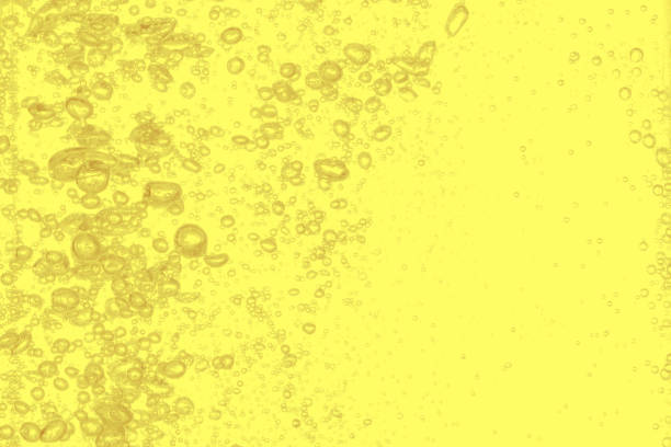 istock Close up water bubbles underwater on yellow background.Yellow bubbles wallpaper. 1211255802
