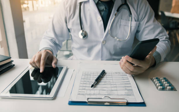 istock Asian doctor using the tablet explaining the patient condition and the treatment result. 1211257620