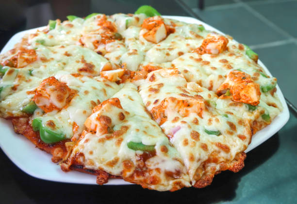 Slide paneer Pizza vegetarian indian food stock photo