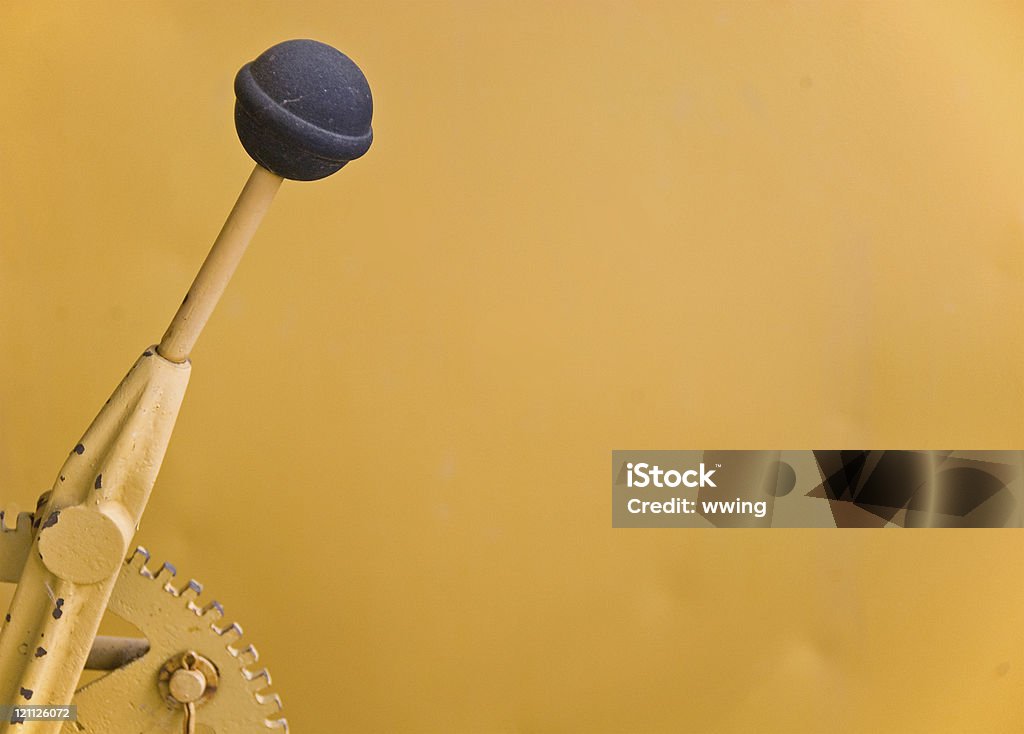 Gear Shift with Copy This gear shifting lever is on an old yellow tractor and the yellow background one of the fenders. Copy space Lever Stock Photo