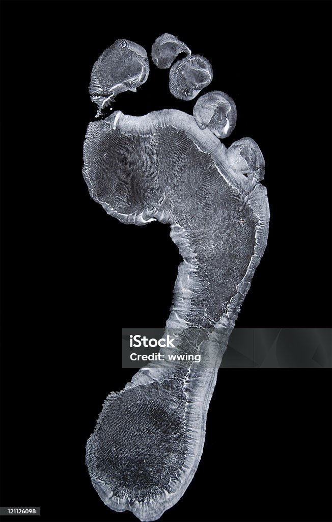 Wet White Footprint A  wet white footprint isolated on a black background with copy space. Footprint Stock Photo