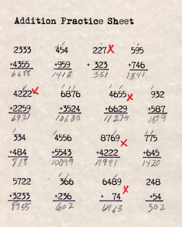 A math sheet showing the corrected problems done by an elementary student.