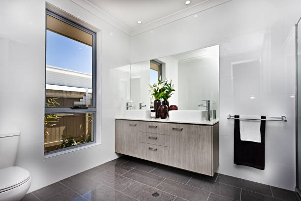 istock Luxury washroom with a window beside a bowl 1211266397