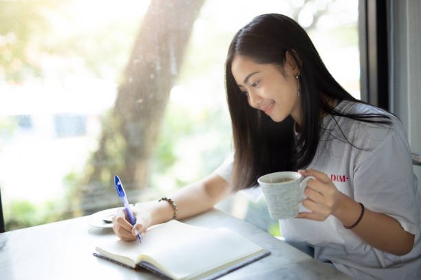 istock Woman relaxed reading a book  at coffee shop 1211266807