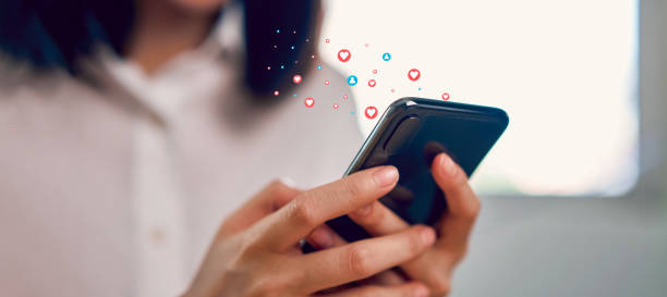 woman hand using smartphone and show heart icon social media. concept social network. - social media sharing marketing business imagens e fotografias de stock