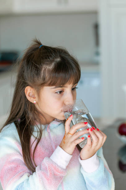 istock Turkish cute little girl drinking water 1211269435