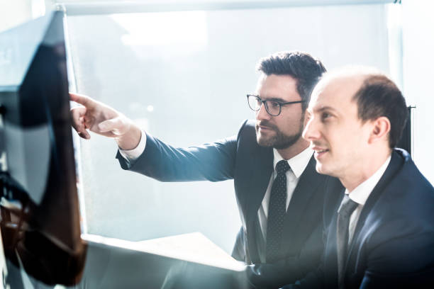 istock Business team analyzing data at business meeting in modern corporate office. 1211270761