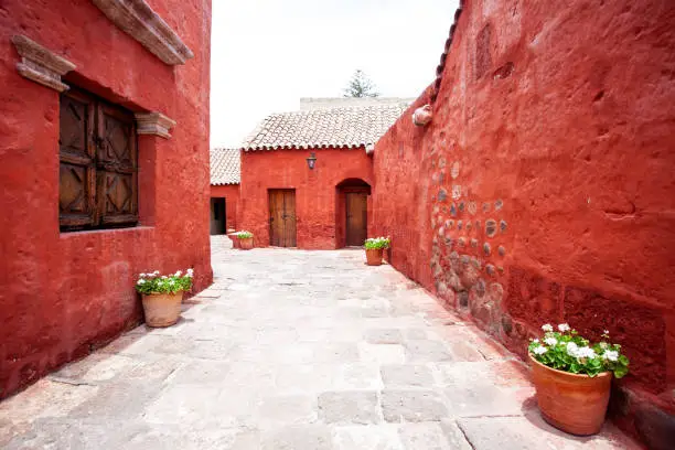 Photo of Street with red-walled houses Saint Catalina, Arequipa, Peru