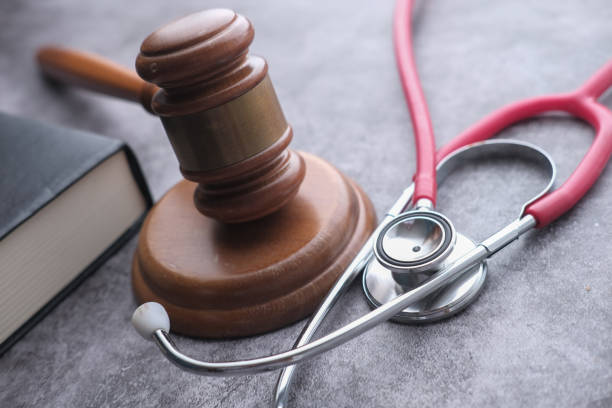 istock close up of gavel, stethoscope and book on table 1211272119