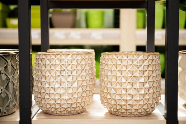 Stylish ceramic flower pots in a store on a shelf.