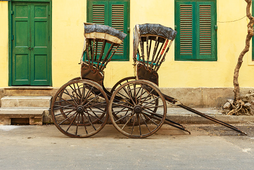 Hand pulled rickshaws are parkedon the street in Kolkata. India