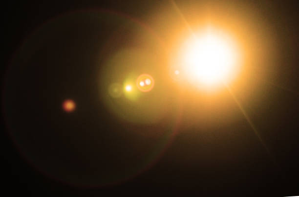 Abstract Natural Sun flare or Far star on the black background - image Toned