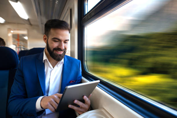 businessman with tablet in the train traveling. - business speed horizontal commercial land vehicle imagens e fotografias de stock