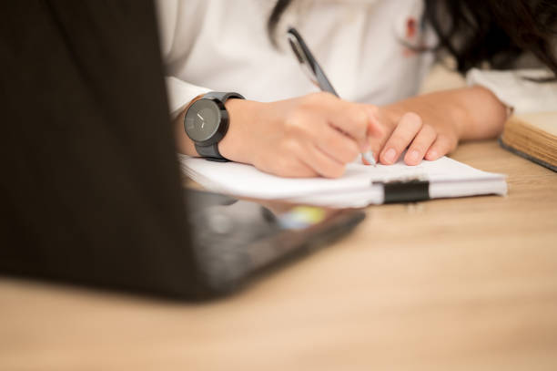 istock Asian working women wearing white shirts sitting at work desks. 1211278792