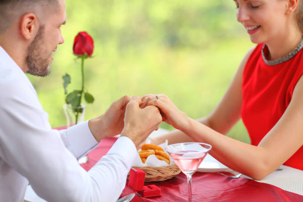 istock man surprising his girlfriend by proposing her on the luxury dinner date in valentine day with copy space 1211278843