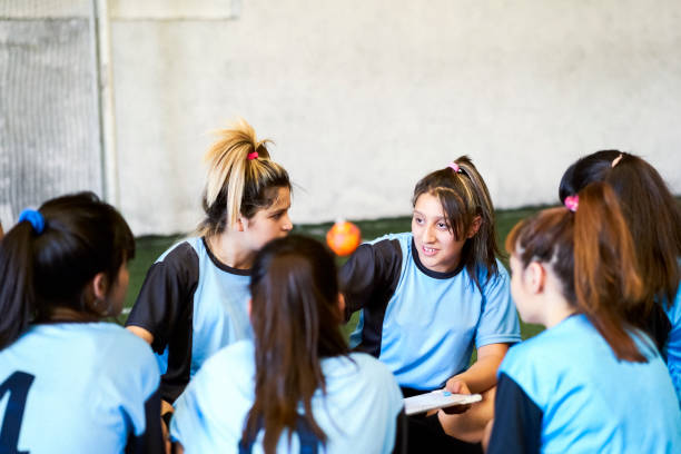 istock Soccer girls discussing game plan at court 1211278982