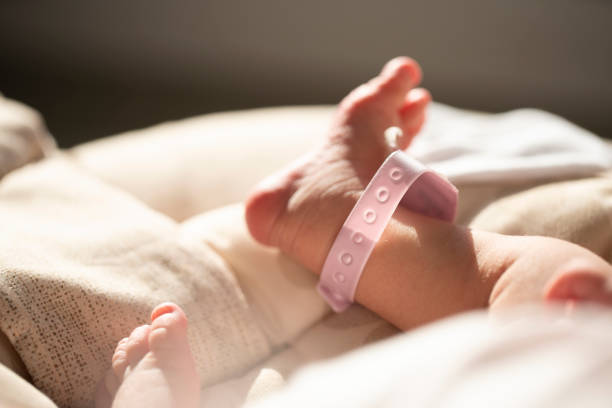istock A baby's foot in mother hands 1211279604