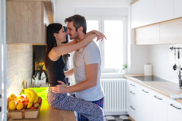 istock Young couple rubbing noses at the kitchen counter 1211281513