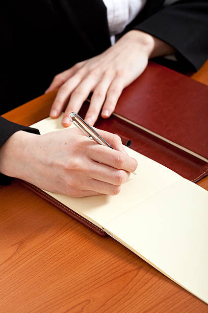 istock Businesswoman doing some paperwork in her office 121128431
