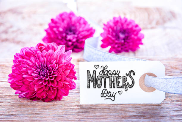 istock Label With Calligraphy Happy Mothers Day. Three Puprle Flower Blossoms 1211286601