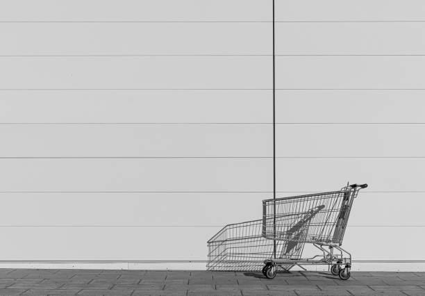 Miniature metal shopping trolley from a supermarket on a black background