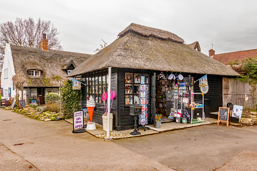 Horning, Norfolk, UK - 2013 March 07 2020. Wooden shop with thatched roof selling gifts and local merchandise in the village of Horning in the heart of the Norfolk Broads