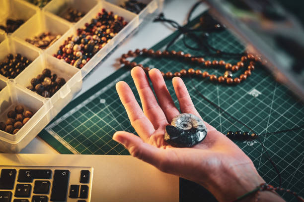 istock Girl is holding ancient shell in hand 1211289842