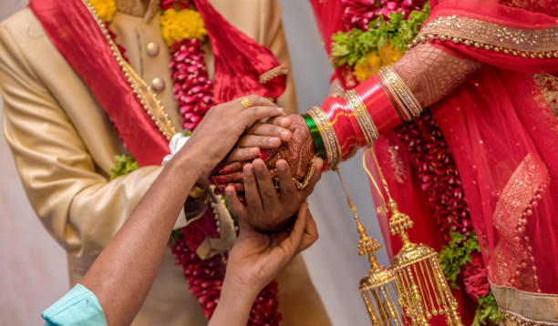 Very Beautiful Photo Of Traditional Indian Wedding Scene Of Hindu Family  Wherein Priest Is Blessing The Relationship Of Newly Married Couple As Per  Vedic Culture Bride And Groom In Ethnic Dress Pics