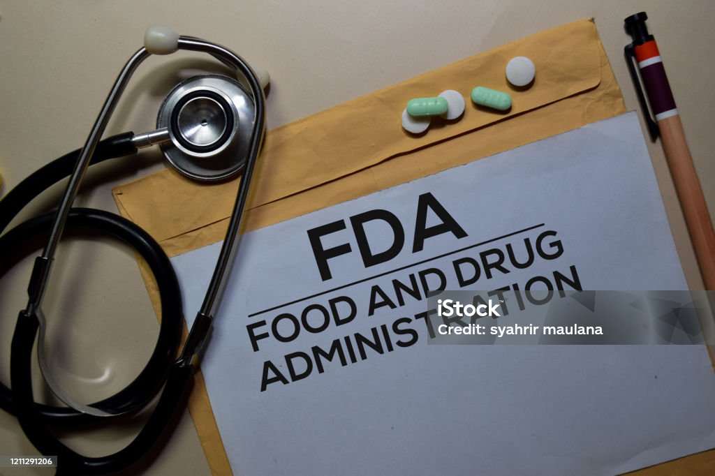 FDA - Food and Drug Administration text on document above brown envelope and stethoscope. Healthcare or medical concept Food and Drug Administration Stock Photo