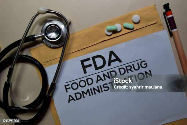 Fda Food And Drug Administration Text On Document Above Brown Envelope And Stethoscope Healthcare Or Medical Concept Stock Photo - Download Image Now