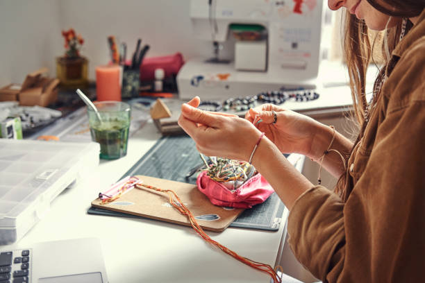 istock Girl is making jevellery from beads 1211291781