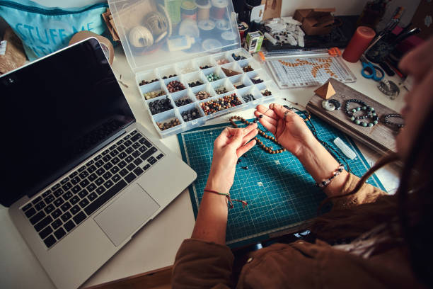 istock Girl is making new beaded jevellery 1211291848