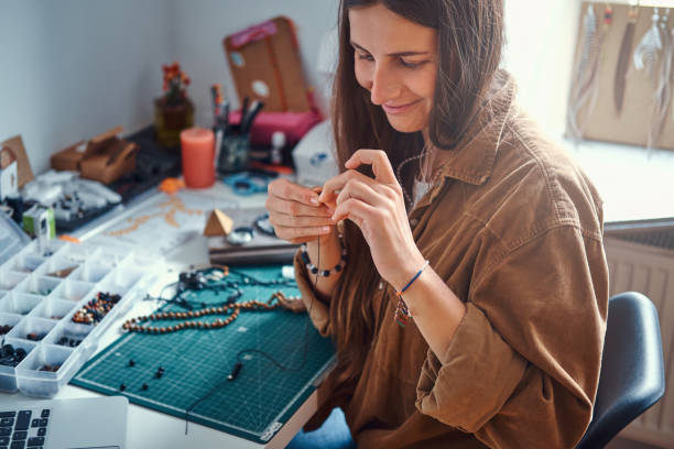 istock Girl is making new beaded jevellery 1211291941